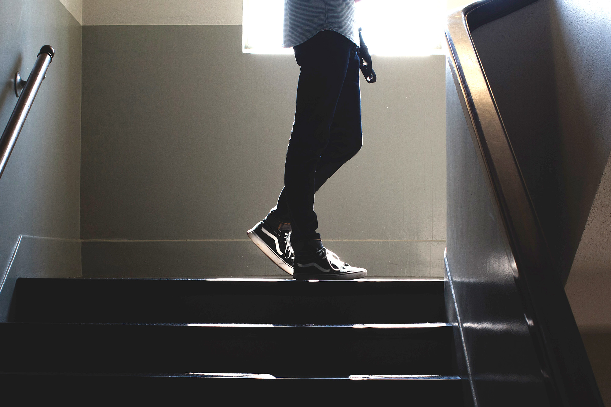 Silhouette of student on stairs at school